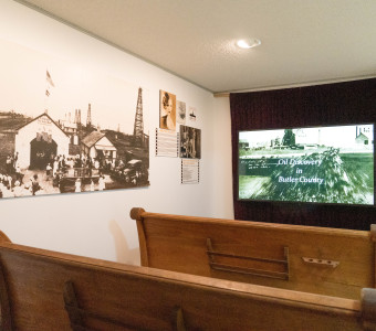 Several pews facing a documentary screening at the Kansas Oil Museum in El Dorado