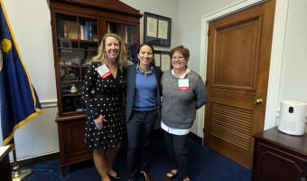 Dené Mosier, Rep. Sharice Davids, and KMA President Cori Sherman North pose in front of a curio cabinet in Davids' office during Museums Advocacy Day 2025.